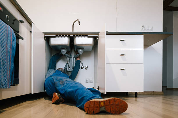 Professional Drain Cleaning technician working in Urbana, IA